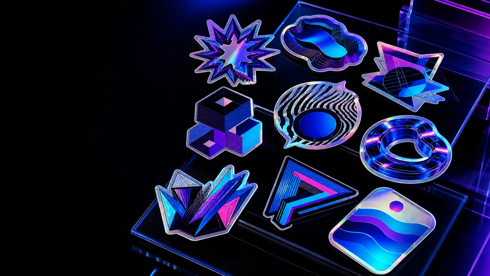 Collection of premium holographic die-cut stickers under blue and violet studio light